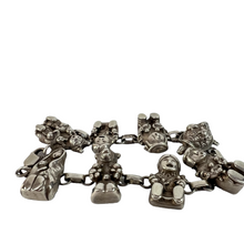 Load image into Gallery viewer, Navajo Storyteller Sterling Silver Bracelet.  This impressive vintage Native American bracelet features eight intricate hand-carved sterling silver storytellers. Each marked Sterling with the Navajo artist Carol Felley maker&#39;s mark. Era: 1970s or5 earlier. Vintage Native American storyteller charm bracelet. Weight: 46 grams.
